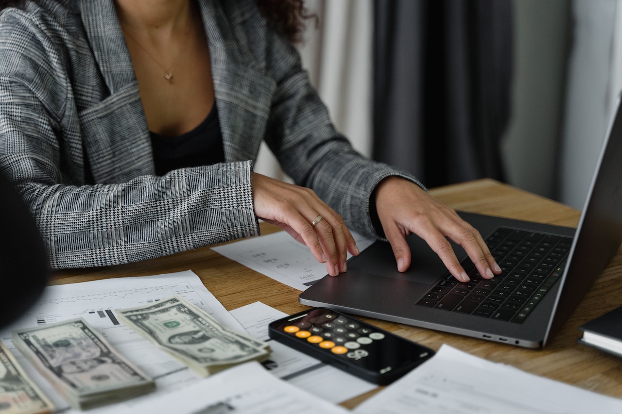 Woman accounting for finances. Photo from Pexels.