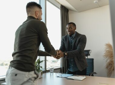 Two men shaking hands, accepting a job offer.
