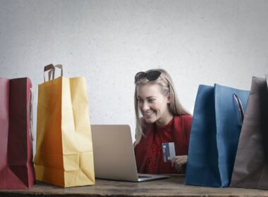 Happy blonde woman shopping online.