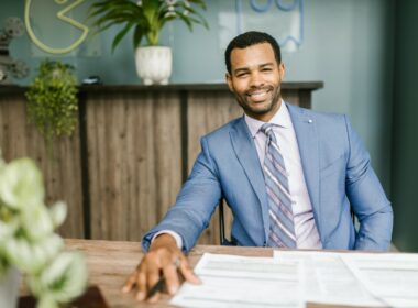 A Black man sitting a desk