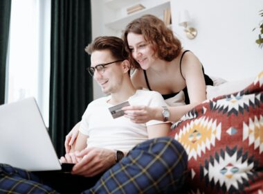 Man and woman making online shopping purchase at home