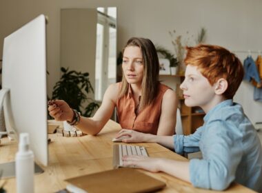 Mom and son working together on computer