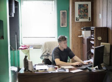 young man working at small office desk