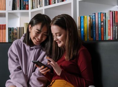 Two Gen Z girls looking at their phone