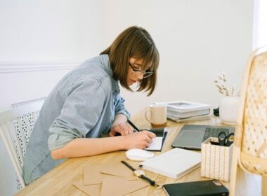 Woman working at a table with laptop in home