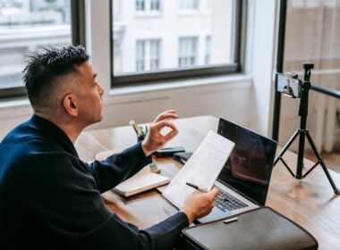 Man working at a desk with papers and laptop