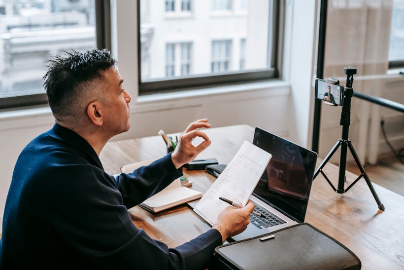 Man working at a desk with papers and laptop