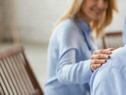 WOman putting hand on shoulder in empathetic gesture