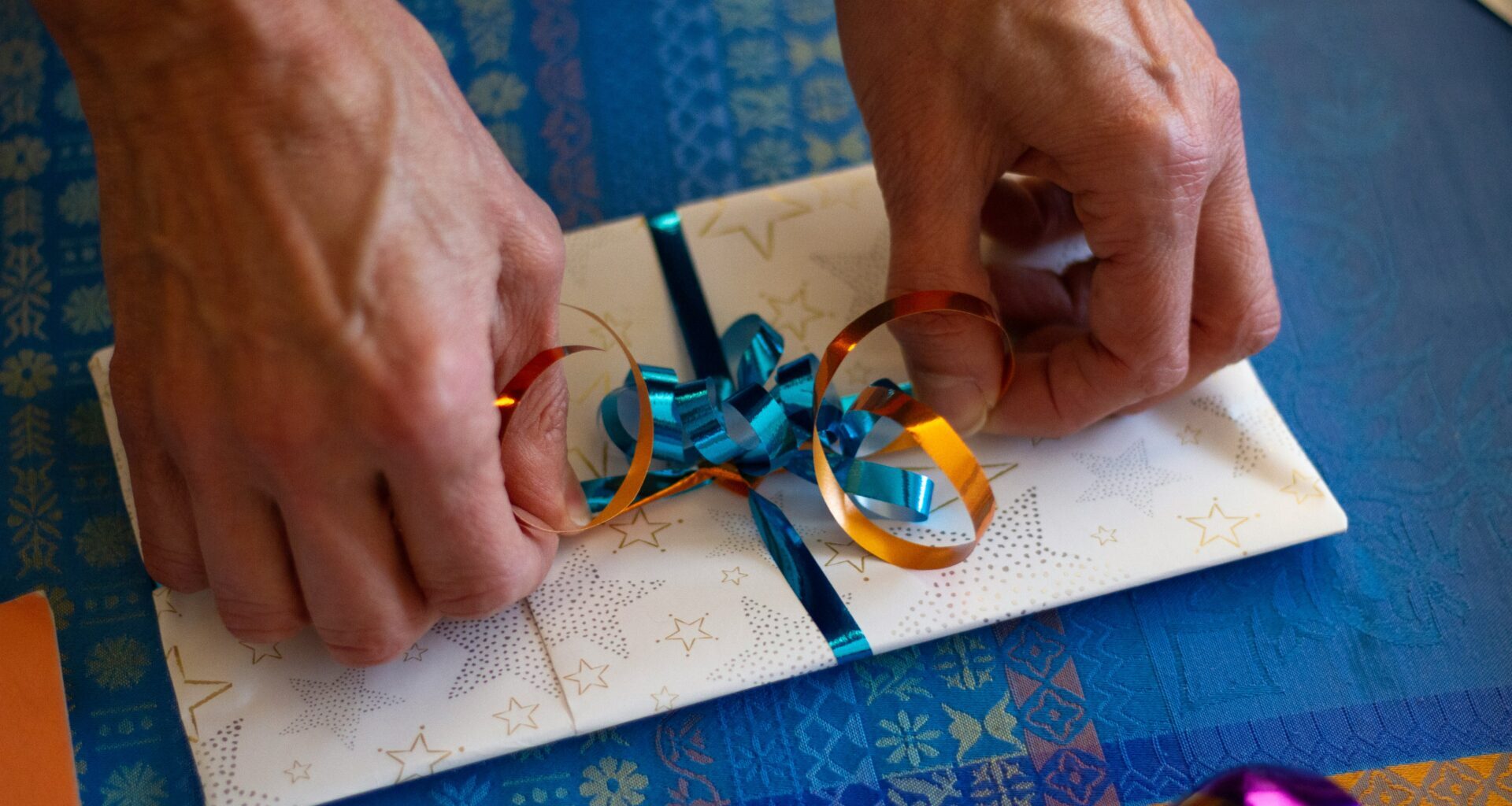 Tying a ribbon on a package for loyalty program