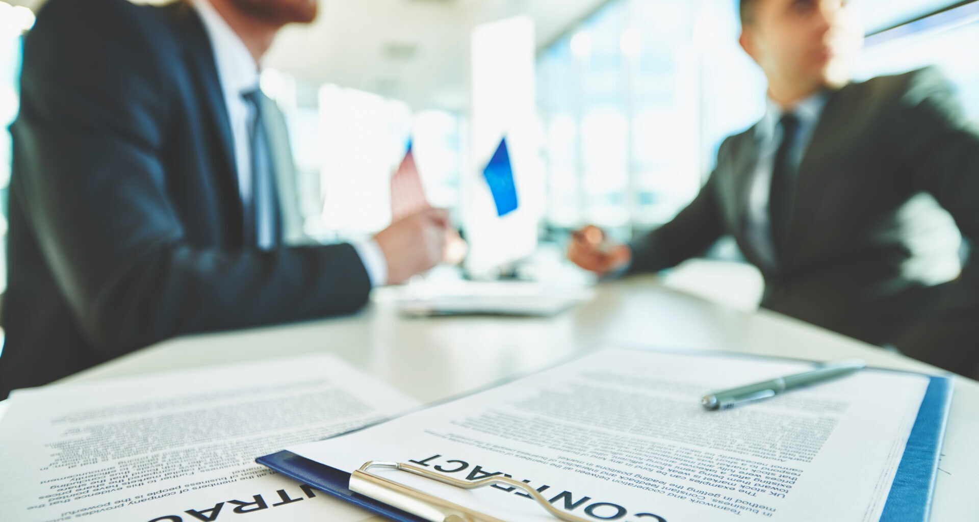 Contracts on desk between colleagues