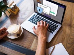 Woman working with laptop and cup of coffee and a password protected screen