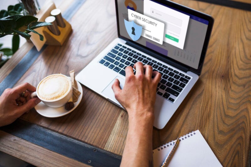 Woman working with laptop and cup of coffee and a password protected screen