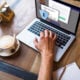 Woman working with laptop and cup of coffee and a password protected screen