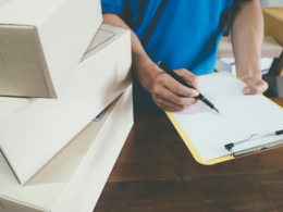 Man holding a clipboard and checking inventory at a small business