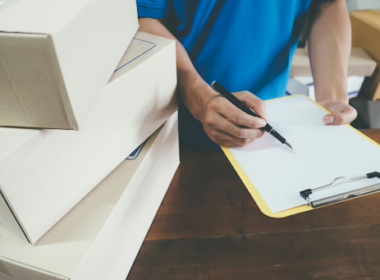 Man holding a clipboard and checking inventory at a small business