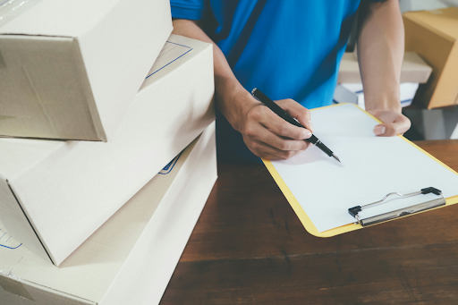 Man holding a clipboard and checking inventory at a small business